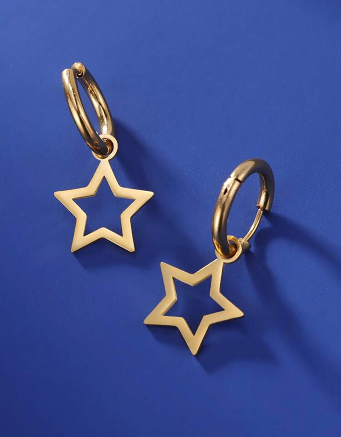 Star dangling golden earrings.